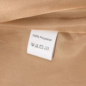 Macro shot of 100% polyester fabric texture and care label on champagne trench coat