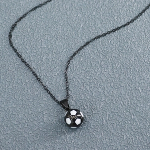 Detailed view of black chain necklace with small black and white soccer ball pendant