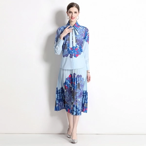 Elegant blue floral two-piece set featuring a tie-neck blouse and pleated midi skirt