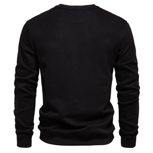 Detailed back view of a black crewneck sweatshirt with ribbed cuffs and hem