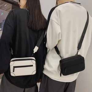 Minimalist crossbody trunk bags in black and white styles with adjustable nylon straps