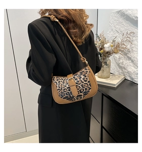 Detail of leopard print shoulder bag with brown leather patchwork and metal buckle