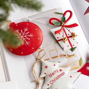 Red and white metal Christmas tree ornaments with star, gift box, and bell designs