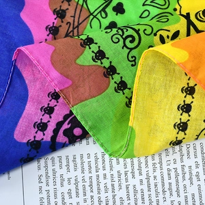 Cotton skull bandana with paisley pattern on vintage book background for outdoor sports