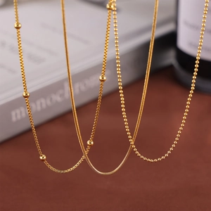 Three layered gold-plated titanium steel necklaces featuring snake and bead chain styles