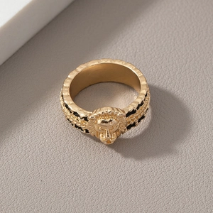 Detailed view of the gold lion head ring with intricate relief and side textured patterns