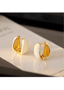 Macro detail of French vintage U-shaped huggie earrings with cream enamel in gold finish