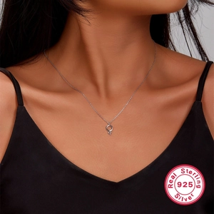 Detail of 925 sterling silver female symbol necklace worn by model showing jewelry luster