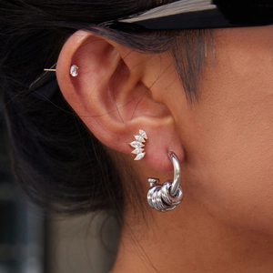 Detailed view of silver multi-layer hoop earrings with marquise zircon ear studs