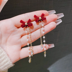 Red flocked bow earrings with long gold tassels, pearls and crystal pendants