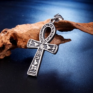Macro shot of ancient Egyptian Ankh cross pendant with intricate hieroglyphic engraving