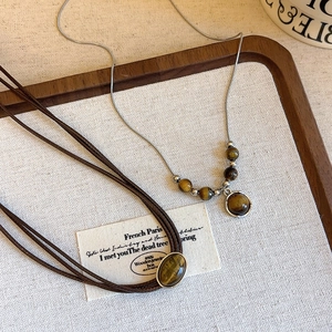 Vintage tiger eye stone necklace with silver chain and brown cord for autumn fashion