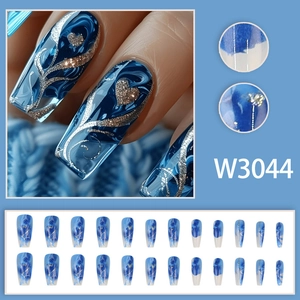 Press-on nail set with long trapezoid blue marble patterns and silver glitter heart details