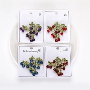 Detailed set of four grape-shaped fruit brooches in purple, red, and blue pearls