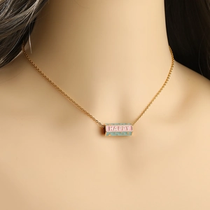 Women's gold necklace with HAPPY enamel pendant and star details on cross chain