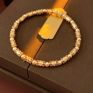 Detail of 18k gold plated beaded bracelet with cubic zirconia and Chinese characters