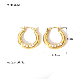 Detail view of 18K gold plated hoop earrings with five small pearls and 21mm size