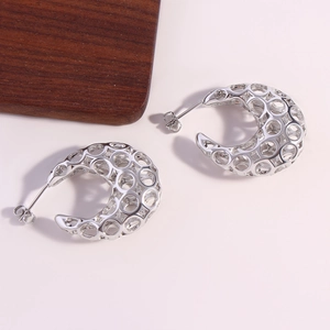 Modern silver C-shaped openwork earrings with geometric hollow design on white background