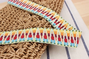 Macro shot of hand-woven straw bag texture with vintage colorful ethnic style shoulder strap