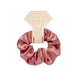 Elegant rose pink satin scrunchie on stylish geometric display card for hair styling
