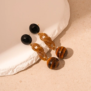Detailed view of vintage resin chain earrings with brown faux tiger eye stone beads