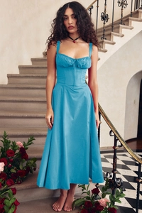 Detail of blue corset maxi dress with drawstring bust on a model in elegant setting