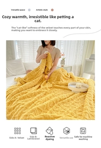 Detail of yellow reversible blanket showing tufted fleece texture and sherpa lining