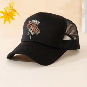 Detail of black trucker hat featuring street style graphic print and mesh back panel