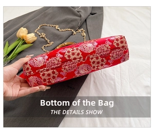 Detailed bottom view of an embroidered red ethnic handbag with traditional floral patterns