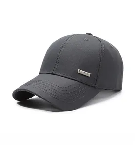 Detailed view of dark grey baseball cap featuring a premium metal plate with Fashion text