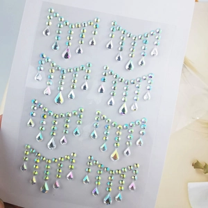 Detail of iridescent AB rhinestone face jewels with teardrop fringe on clear backing