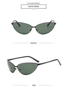 Detail view of cat-eye sunglasses with thin black metal frames and green lenses