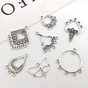 Detailed macro view of seven vintage silver alloy charms for DIY jewelry making