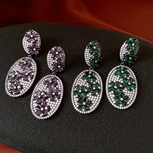 Vintage oval floral drop earrings with purple and green zircon crystals in dark metal