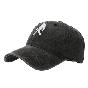 Washed black cotton baseball cap featuring white Bigfoot silhouette embroidery at 45-degree angle