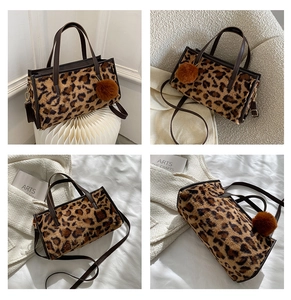 Detail of leopard print faux fur tote bag with brown leather handles and pompom charm