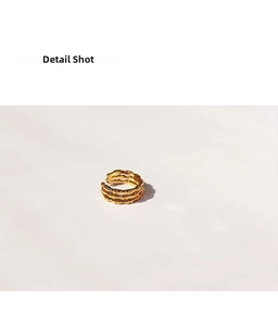 Close-up of triple-layered golden bamboo texture open ring with polished finish
