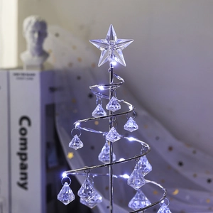 Macro shot of silver metal spiral Christmas tree lamp with crystal pendants and star topper