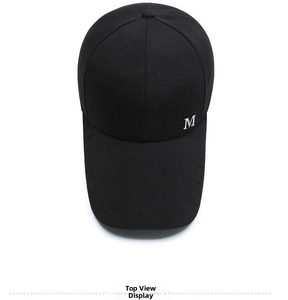 Detailed top view of black canvas baseball cap with white embroidered M letter decoration