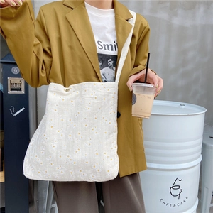 Street style view of white floral daisy canvas tote bag with yellow blazer and white T-shirt