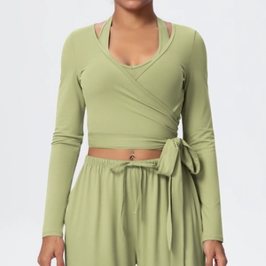 Detail of avocado green wrap-style long sleeve yoga top and high-waist drawstring pants