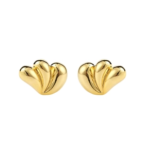 Detailed macro view of triple stacked heart-shaped earrings in polished 18k gold plating