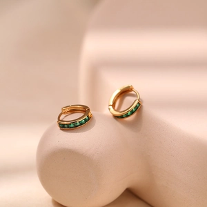 Detail of 18K gold-plated small hoop earrings set with square-cut green zircon stones