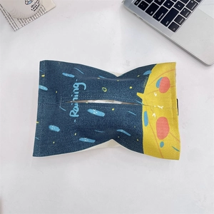 Detail of creative cartoon fabric tissue box holder with Raining print on white desk
