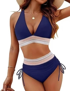 Detail of high-waisted navy bikini bottoms with side drawstrings and wavy knit band