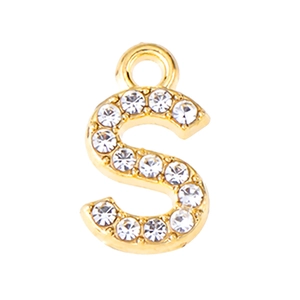 Macro detail of a gold letter S pendant with white crystals and hanging loop