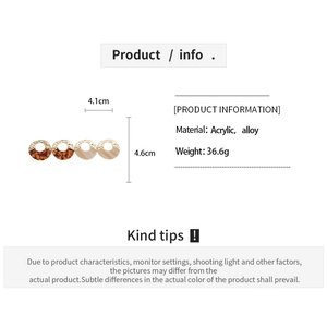 Detail view of acrylic and alloy geometric earrings with tortoiseshell and marble patterns