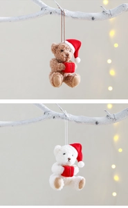Close-up of brown and white plush teddy bears with red Christmas hats and gift boxes