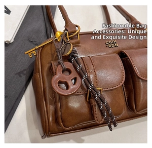 Detailed macro view of the brown leather Boston bag featuring dual front flap pockets