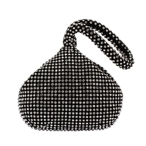 Macro detail of teardrop rhinestone clutch with black and white crystal patterns